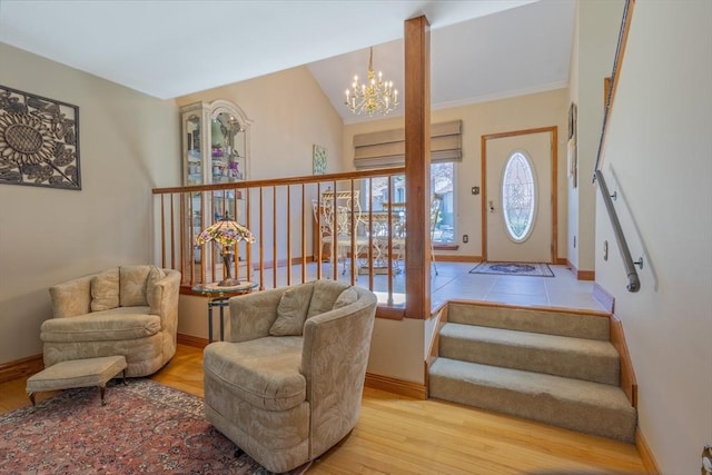 foyer entrance featuring baseboards, a notable chandelier, and wood finished floors