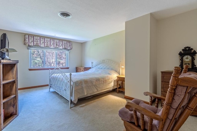 carpeted bedroom with baseboards and visible vents