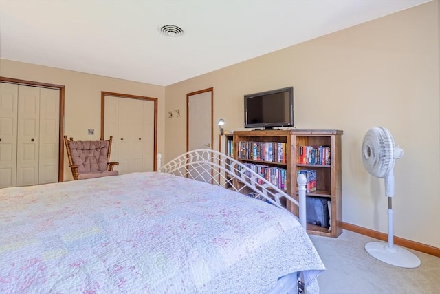 carpeted bedroom featuring baseboards and visible vents