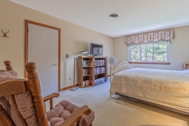 bedroom featuring baseboards, light carpet, and visible vents