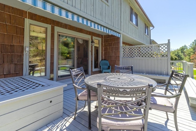 wooden terrace with outdoor dining area