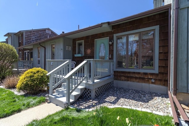 view of exterior entry featuring covered porch