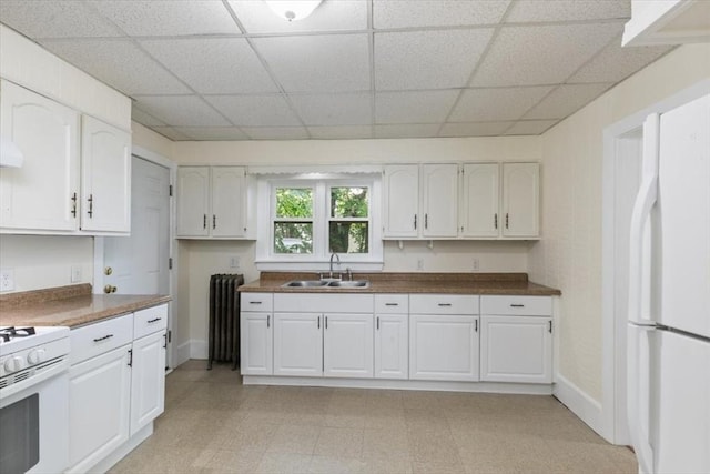 39-41 Arlington St, Methuen, MA 01844 - kitchen with white appliances, a sink, a drop ceiling, white cabinetry, and radiator heating unit