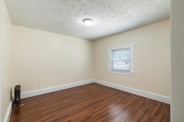 39-41 Arlington St, Methuen, MA 01844 - empty room featuring dark wood-type flooring, baseboards, and a textured ceiling