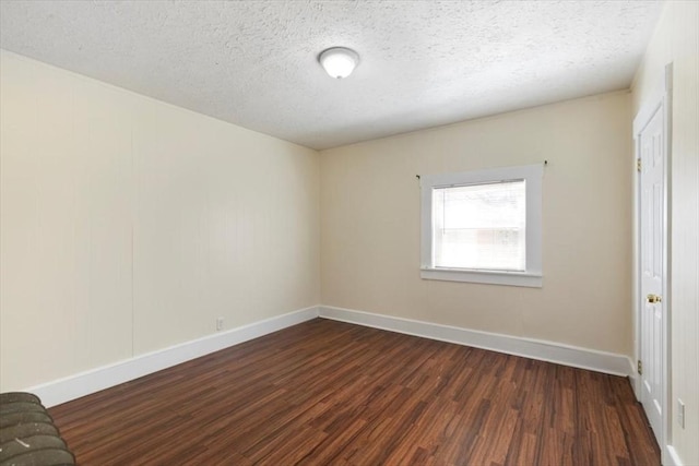39-41 Arlington St, Methuen, MA 01844 - unfurnished bedroom featuring dark wood-type flooring, baseboards, and a textured ceiling