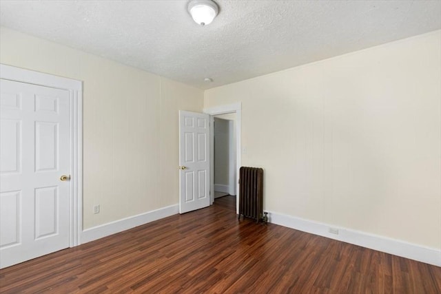 39-41 Arlington St, Methuen, MA 01844 - unfurnished room with radiator, dark wood-style flooring, baseboards, and a textured ceiling