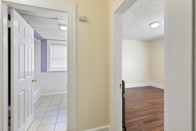 39-41 Arlington St, Methuen, MA 01844 - corridor featuring baseboards, a textured ceiling, and light tile patterned floors