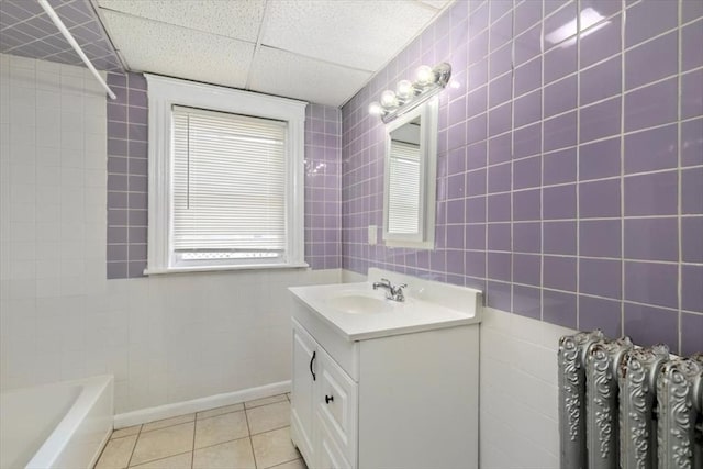 39-41 Arlington St, Methuen, MA 01844 - bathroom featuring vanity, a tub, tile walls, tile patterned floors, and a drop ceiling