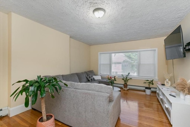 39-41 Arlington St, Methuen, MA 01844 - living area with light wood-type flooring, a textured ceiling, baseboards, and baseboard heating