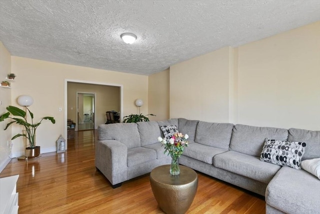 39-41 Arlington St, Methuen, MA 01844 - living room with light wood-type flooring, a textured ceiling, and baseboards