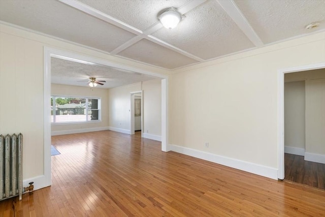 39-41 Arlington St, Methuen, MA 01844 - unfurnished room with radiator heating unit, a textured ceiling, hardwood / wood-style flooring, baseboards, and a ceiling fan