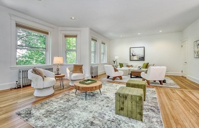 68 Parkman St Unit 3, Brookline, MA 02446 - living room featuring radiator, wood finished floors, and recessed lighting