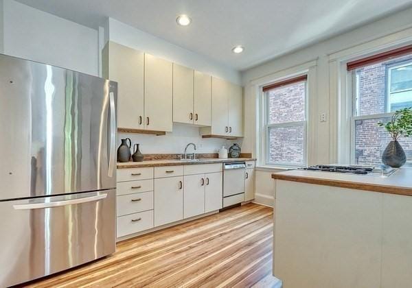 68 Parkman St Unit 3, Brookline, MA 02446 - kitchen featuring freestanding refrigerator, dishwasher, light wood-type flooring, recessed lighting, and light countertops