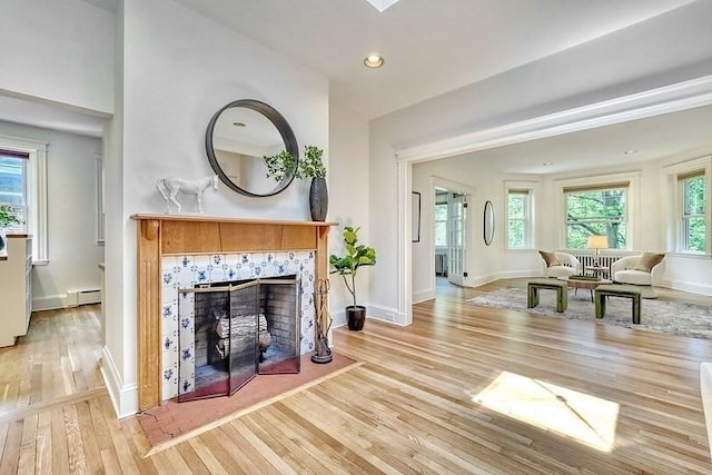68 Parkman St Unit 3, Brookline, MA 02446 - living area featuring wood finished floors, baseboard heating, a tile fireplace, and recessed lighting
