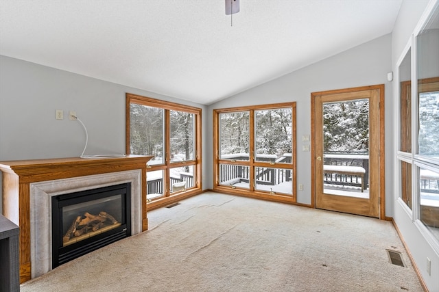 unfurnished sunroom with lofted ceiling, ceiling fan, and plenty of natural light