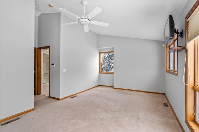 unfurnished room with ceiling fan, light carpet, and vaulted ceiling