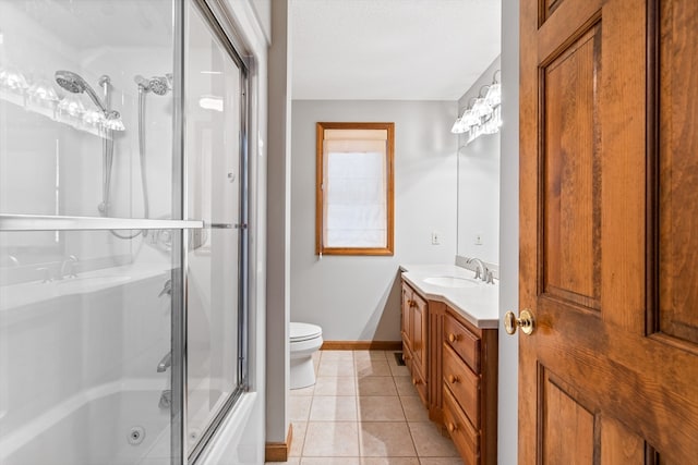 full bathroom featuring combined bath / shower with glass door, tile flooring, oversized vanity, and toilet