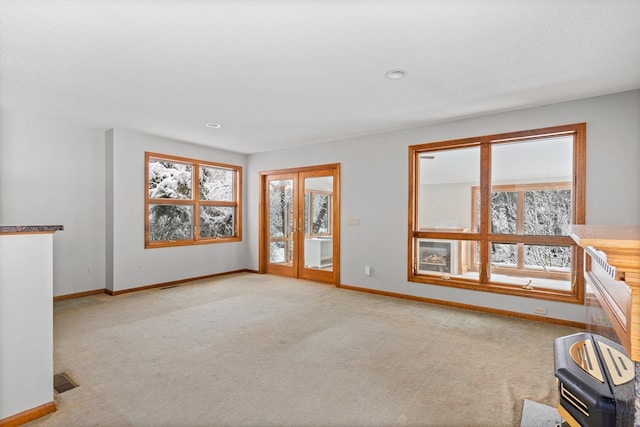 empty room featuring light carpet and french doors