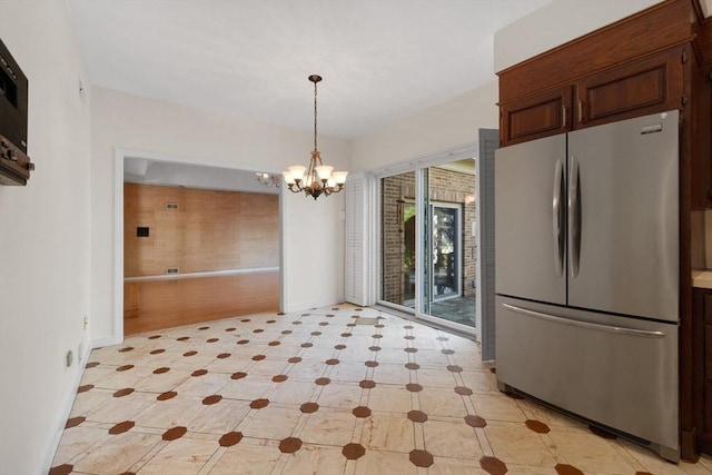 21 Wildewood Dr, Lynnfield, MA 01940 - unfurnished dining area with baseboards and a chandelier