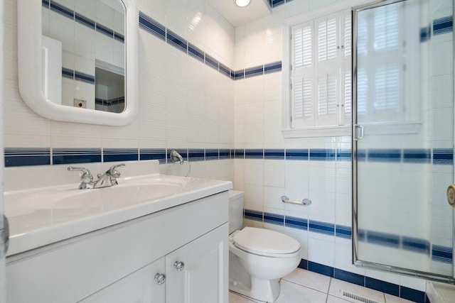 21 Wildewood Dr, Lynnfield, MA 01940 - bathroom with toilet, tile walls, a shower stall, vanity, and tile patterned flooring