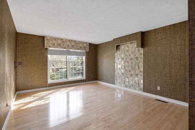 21 Wildewood Dr, Lynnfield, MA 01940 - empty room with wood finished floors, baseboards, and visible vents