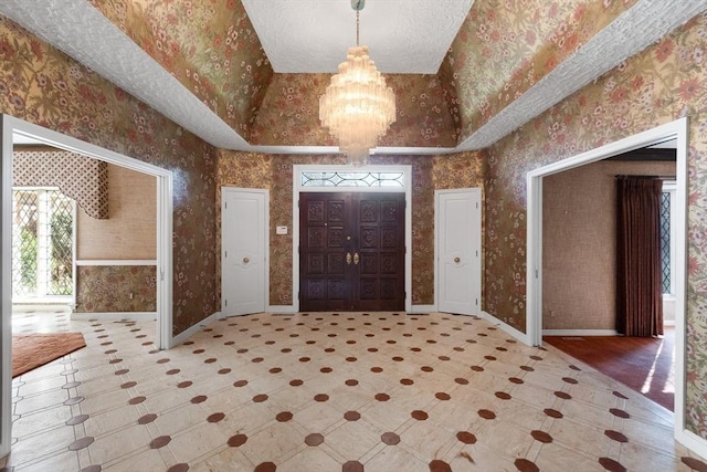21 Wildewood Dr, Lynnfield, MA 01940 - foyer featuring a notable chandelier, baseboards, wallpapered walls, tile patterned floors, and lofted ceiling