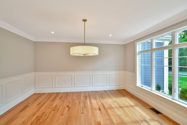 7 Stage Coach Rd, Lexington, MA 02421 - spare room featuring a wainscoted wall, visible vents, light wood-style floors, and crown molding