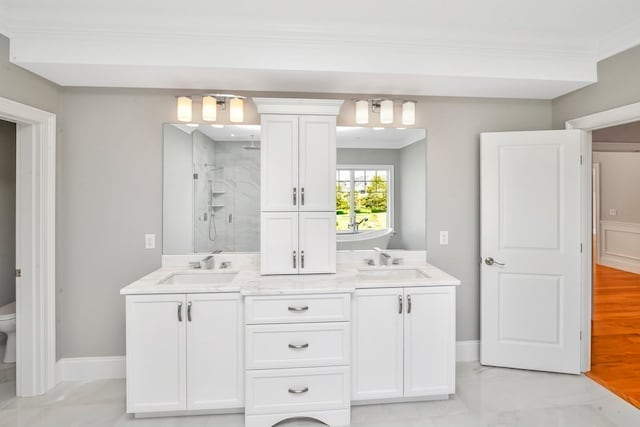 bathroom featuring hardwood / wood-style floors, double vanity, toilet, a shower, and ornamental molding