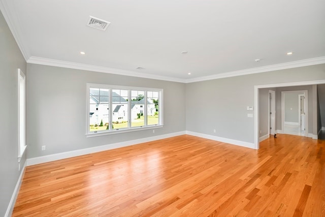 unfurnished room with crown molding and light hardwood / wood-style flooring