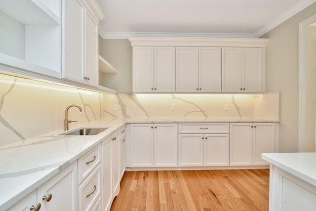 7 Stage Coach Rd, Lexington, MA 02421 - kitchen featuring light wood finished floors, a sink, ornamental molding, and open shelves