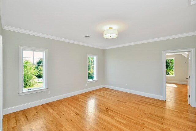 unfurnished room with light hardwood / wood-style floors and ornamental molding