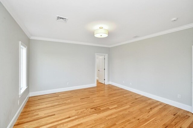 unfurnished room with light wood-type flooring and ornamental molding