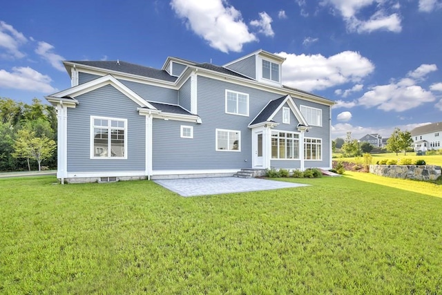 7 Stage Coach Rd, Lexington, MA 02421 - back of property featuring roof with shingles, entry steps, a yard, and a patio