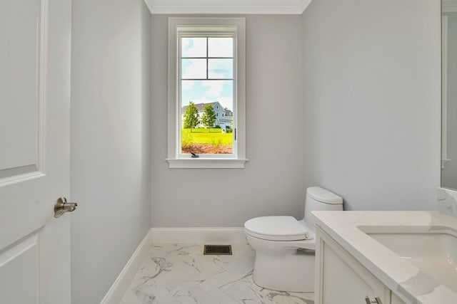 bathroom with ornamental molding, vanity, tile patterned flooring, and toilet