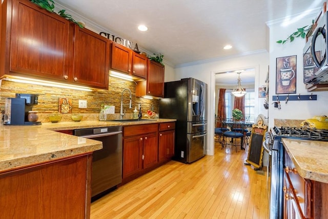 41 Whispering Pine Cir Unit 41, Worcester, MA 01606 - kitchen featuring stainless steel appliances, a sink, crown molding, light wood-style floors, and backsplash