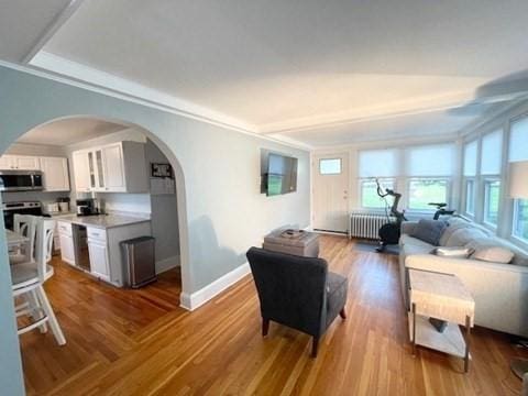 192 Salem St, Wakefield, MA 01880 - living area featuring radiator, arched walkways, wood finished floors, and ornamental molding