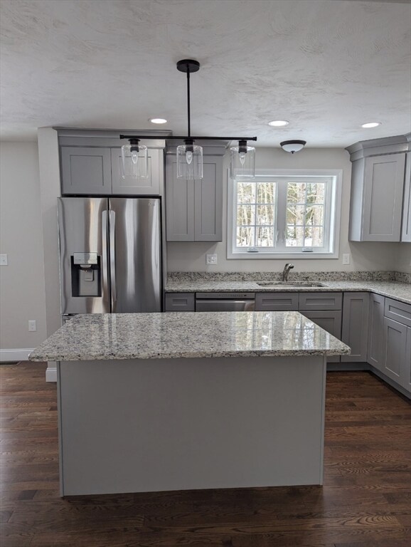 kitchen featuring gray cabinets, dark wood-type flooring, stainless steel appliances, and sink