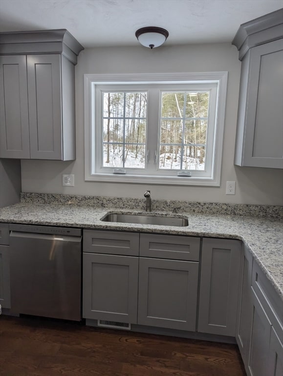 kitchen featuring dishwasher, light stone countertops, sink, and gray cabinetry