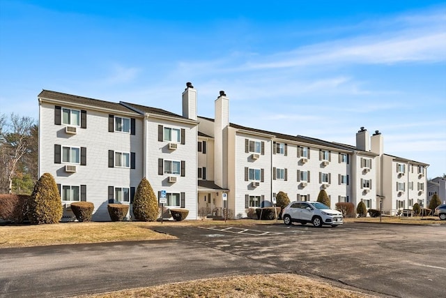 view of building exterior with uncovered parking