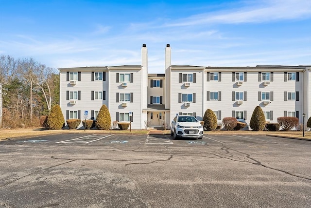 view of building exterior featuring uncovered parking