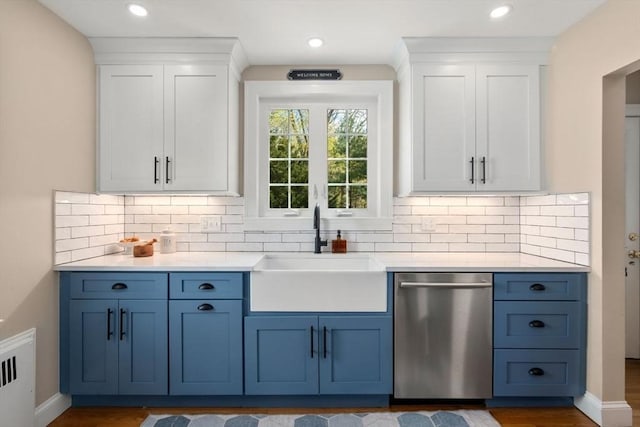 kitchen with dishwasher, a sink, blue cabinets, white cabinetry, and light countertops
