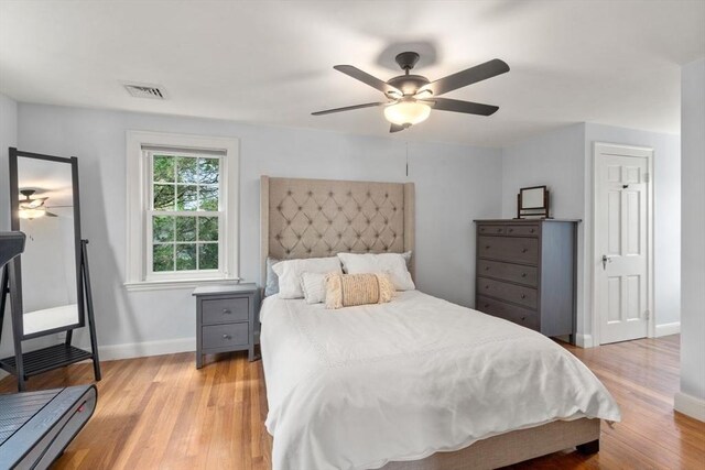 bedroom with baseboards, light wood-type flooring, and ceiling fan