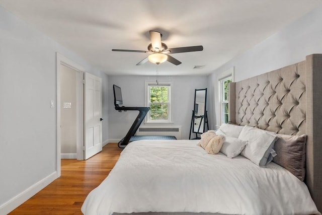 bedroom with baseboards, wood finished floors, and ceiling fan