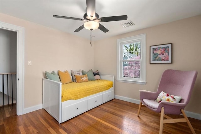 bedroom with wood finished floors, baseboards, and a ceiling fan
