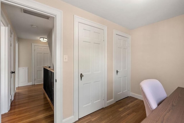unfurnished office with wood finished floors and baseboards