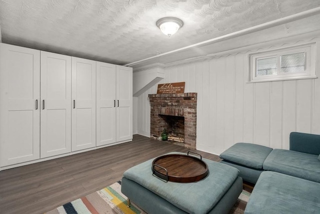living area with dark wood-style floors and a fireplace