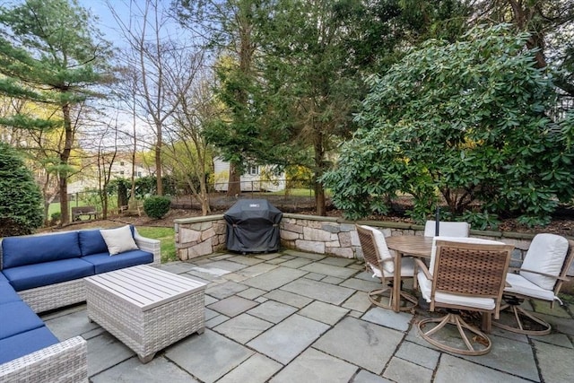 view of patio with grilling area, outdoor lounge area, outdoor dining space, and a fenced backyard
