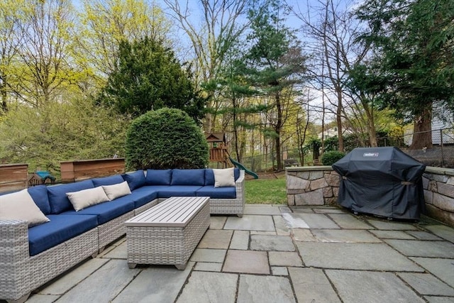 view of patio with outdoor lounge area, area for grilling, and a fenced backyard