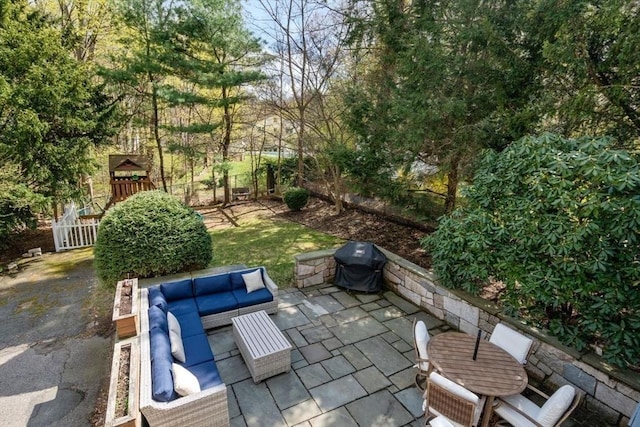 view of patio with an outdoor living space, grilling area, and fence