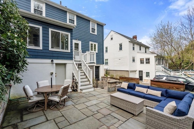 back of house featuring stairway, an outdoor hangout area, a patio area, and outdoor dining area